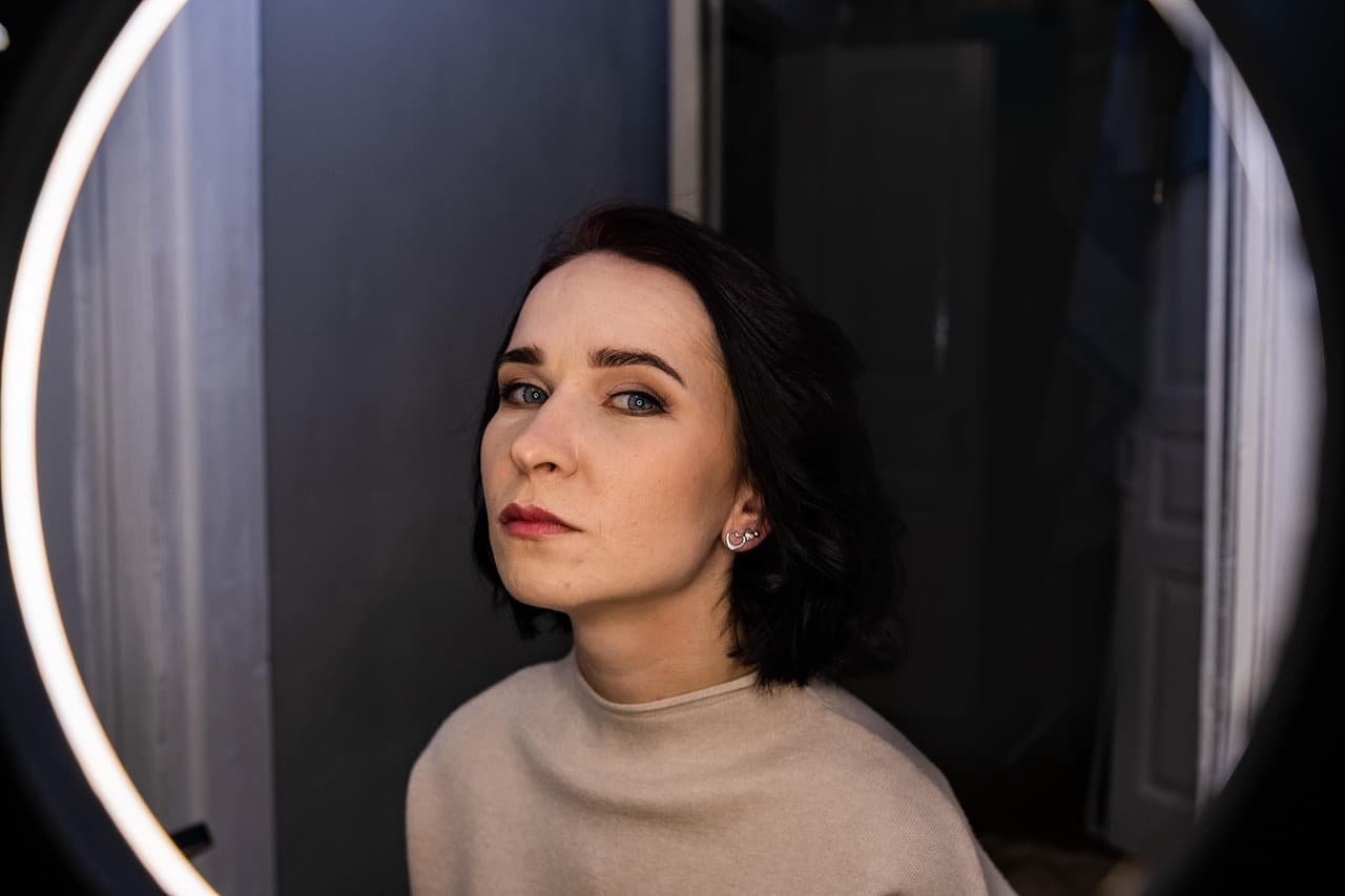 Woman with a fresh dark bob in front of a salon mirror