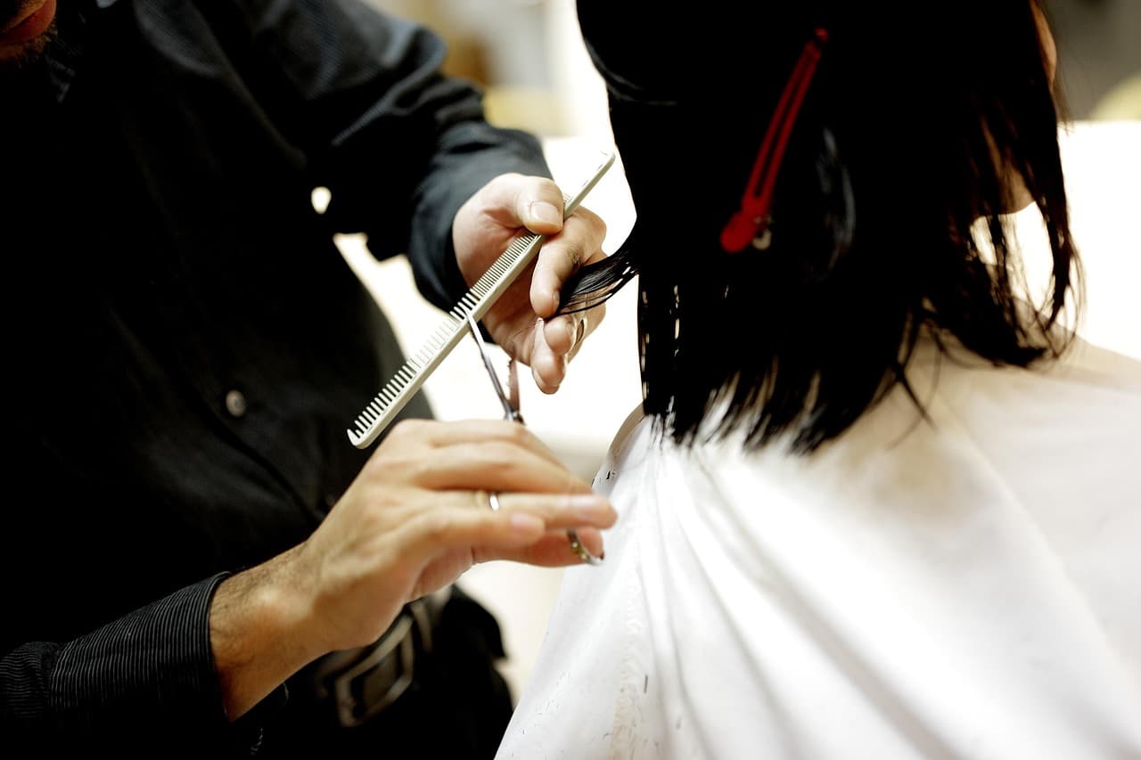 Scissors cutting a dark bob